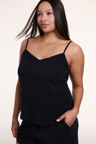 In a studio setting, Alana wears the Sunday Pima Tank in Black, showing the soft fabric, thin straps, and relaxed fit. sizing: Alana wears size Large