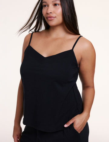 In a studio setting, Alana wears the Sunday Pima Tank in Black, showing the soft fabric, thin straps, and relaxed fit. sizing: Alana wears size Large