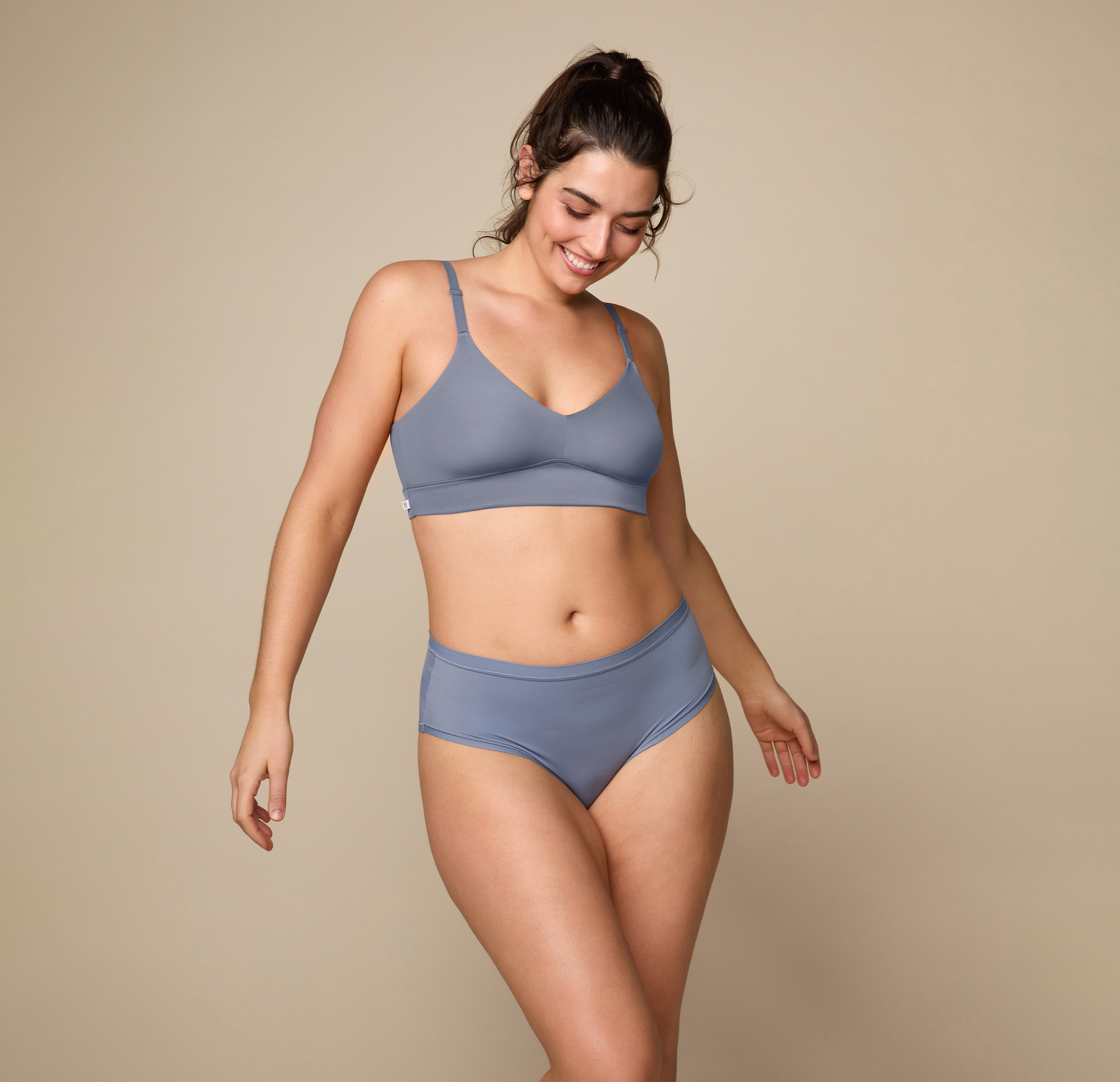Woman wearing the Bliss Triangle Bralette in the color Steel. sizing: Kate wears size Large. Sizes L-6XL have higher center in front for additional support.
