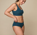 Woman wearing the Cloud Cotton Hiphugger underwear in the color Indigo