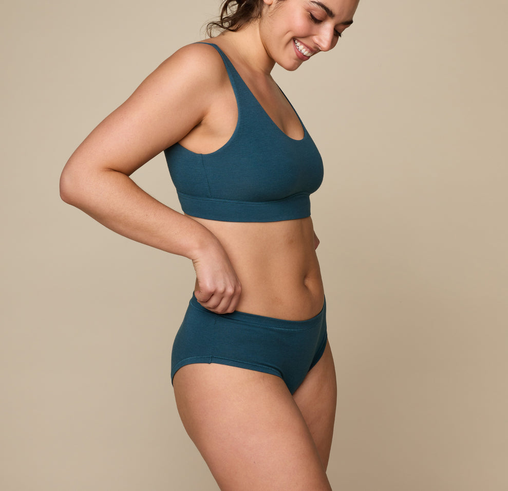 Woman wearing the Cloud Cotton Hiphugger underwear in the color Indigo