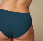 Woman wearing the Cloud Cotton Hiphugger underwear in the color Indigo