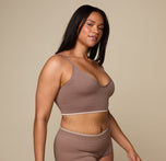 Woman wearing the Lounge Triangle Bralette in the color Oyster