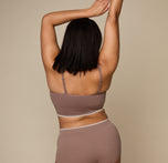 Woman wearing the Lounge Triangle Bralette in the color Oyster