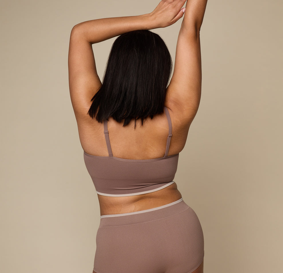 Woman wearing the Lounge Triangle Bralette in the color Oyster
